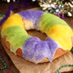 King Cake on brown paper with Mardi Gras decoration