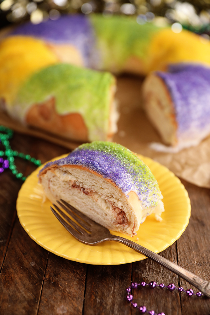 Slice of King Cake on yellow plate