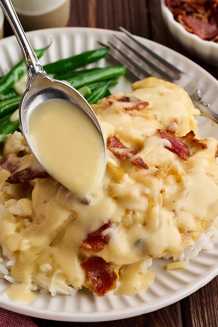 Spooning sauce over Chicken.