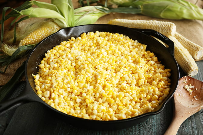 Fried corn surrounded by corn cobs