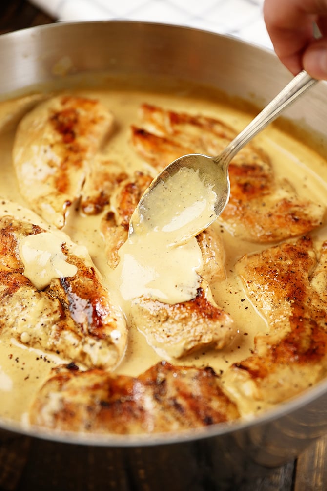 Cream Cheese Pan sauce being spooned over seared chicken breasts