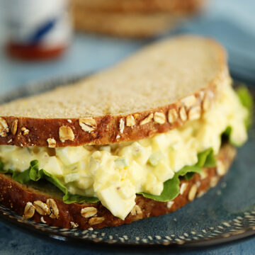 egg salad sandwich on bread with lettuce.