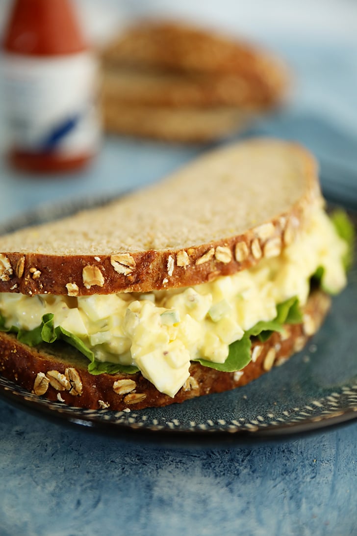 egg salad sandwich on bread with lettuce.