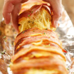Slice of Cheesy Swiss Bacon Bread with cheese pull