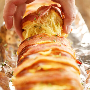 Slice of Cheesy Swiss Bacon Bread with cheese pull