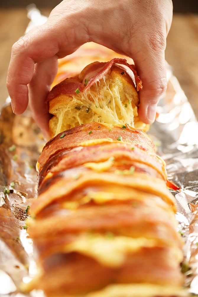 Slice of Cheesy Swiss Bacon Bread with cheese pull