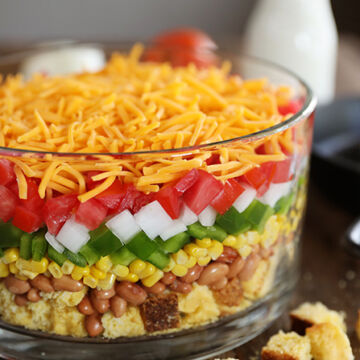 Layered Cornbread Salad in clear glass bowl