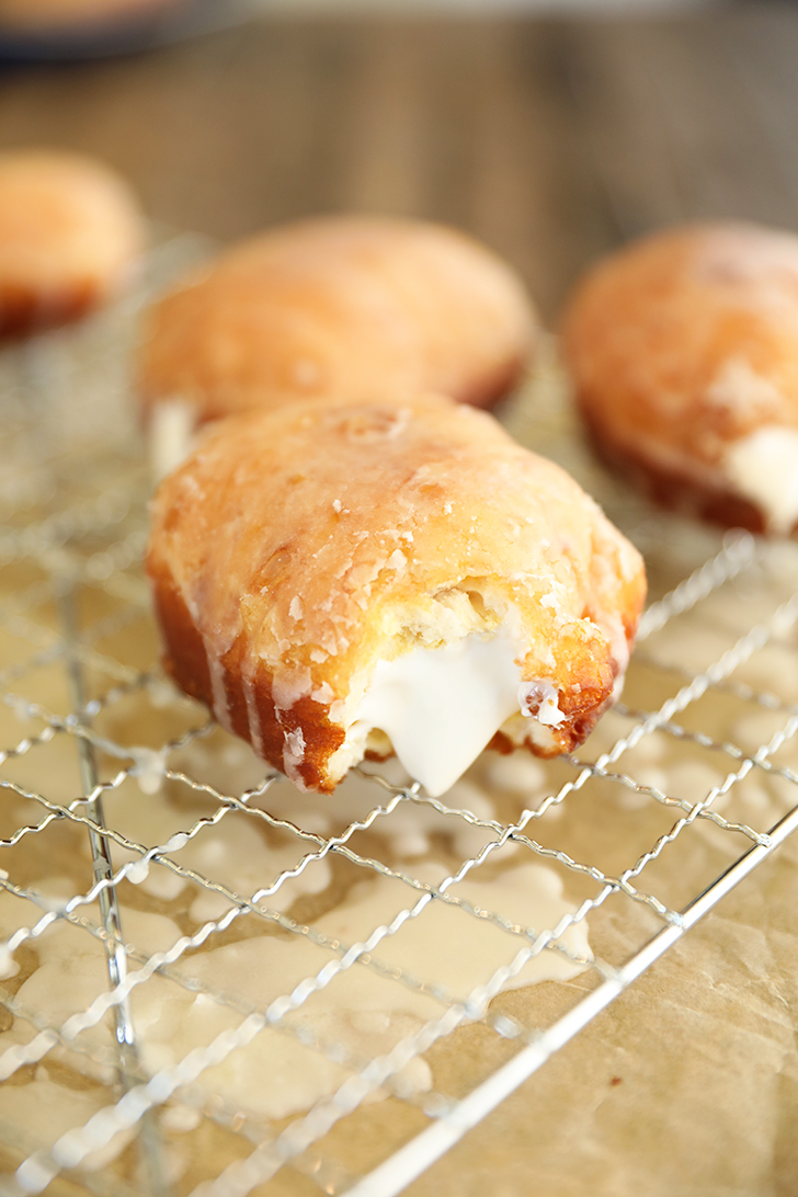 Cream filled doughnut with bite missing.