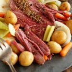 Slow cooker corned beef and cabbage in blue serving dish