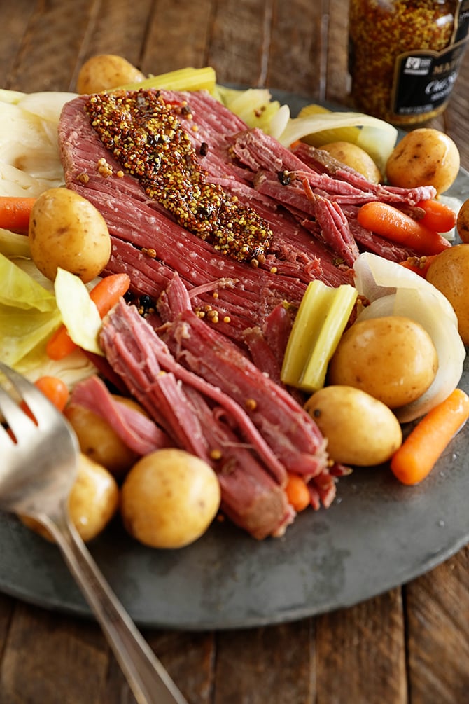 Slow cooker corned beef and cabbage in blue serving dish