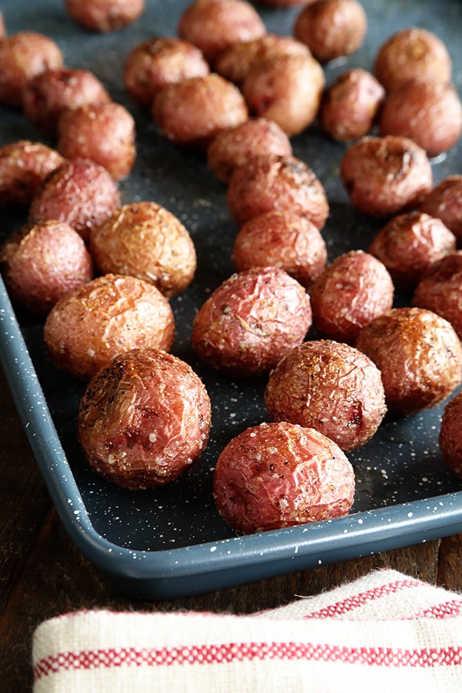 Roasted New Potatoes on baking pan close photo