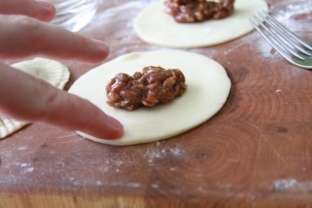 Using water on the edges to seal the pie crust