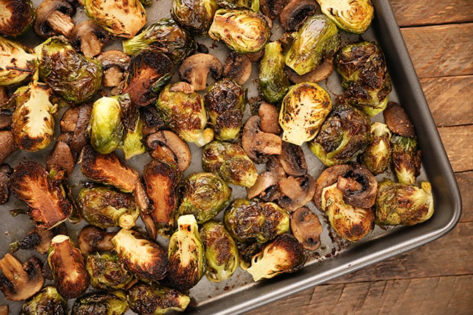Roasted Brussels Sprouts with Mushrooms on a baking sheet