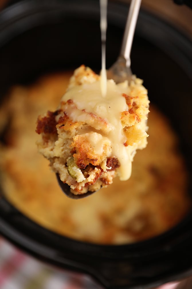 Gravy being poured over a scoop of Slow Cooker Cornbread Dressing
