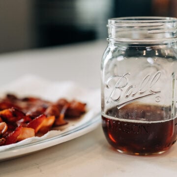 plate of bacon with jar of bacon grease.