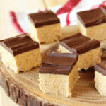 Peanut Butter Ball Bars on wooden platter.