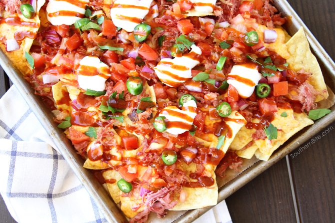 These Southern Sheet Pan Nachos combine smoky pulled pork, melty pimiento cheese, and all your favorite toppings into one amazing pan of food!