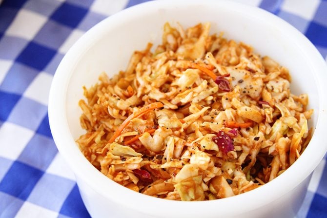 Give your taste buds a kick with this BBQ Cole Slaw - it has tangy bbq sauce as the base for the dressing! 