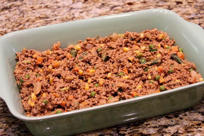 This Cheesy Beef Bake with Onion Rings is a delicious twist on the Classic Tater Tot Casserole!