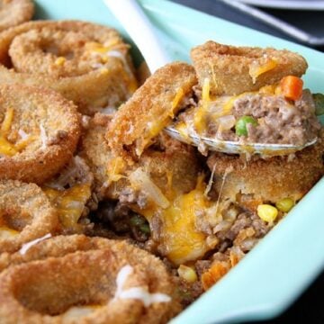 This Cheesy Beef Bake with Onion Rings is a delicious twist on the Classic Tater Tot Casserole!