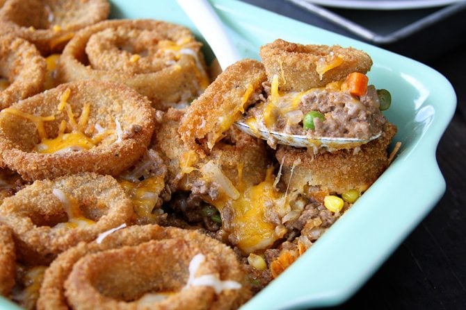 This Cheesy Beef Bake with Onion Rings is a delicious twist on the Classic Tater Tot Casserole!