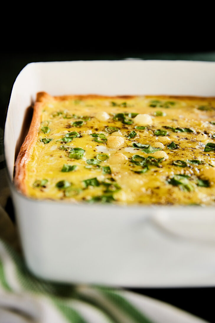 Ham and swiss breakfast casserole in a white dish.