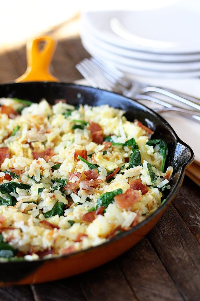 Hash browns, eggs, spinach, and chicken bacon combine to make this lightened-up version of a breakfast classic!