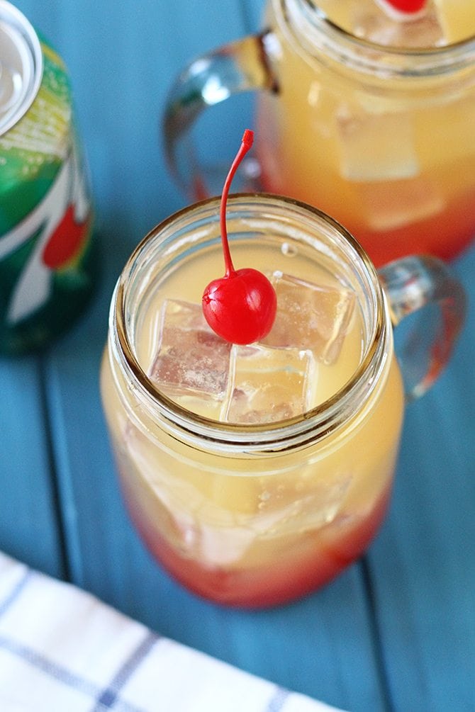 This kid-friendly Pineapple Sunrise "cocktail" made with 7UP is the perfect thing to keep the kiddos cool this summer! It's pretty cool looking, too! #ad