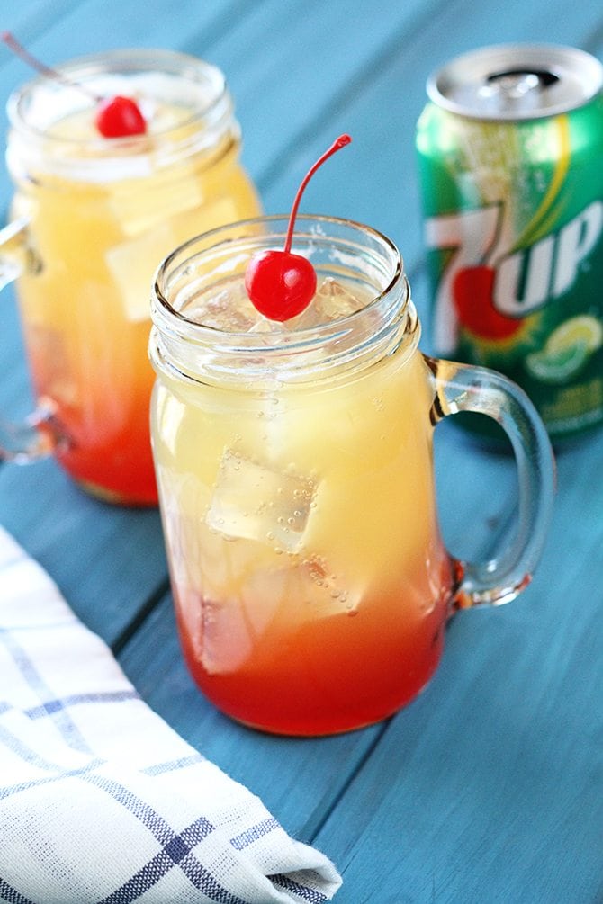 This kid-friendly Pineapple Sunrise "cocktail" made with 7UP is the perfect thing to keep the kiddos cool this summer! It's pretty cool looking, too! #ad