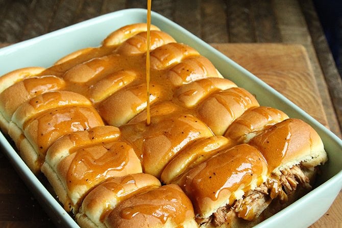 These BBQ Chicken Sliders with Dill Pickle Slaw are perfect for your next tailgate or a casual dinner with friends.  Plus they're made right in the slow cooker!