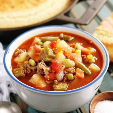 Vegetable Beef Soup with cornbread in background