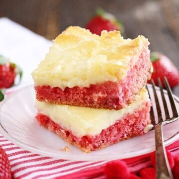 Slice of Strawberry Chess Bars with fresh strawberries in background