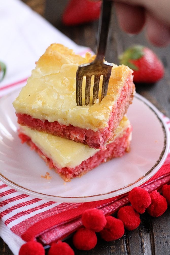 Slices of Strawberry Chess Bars with fork stuck inside