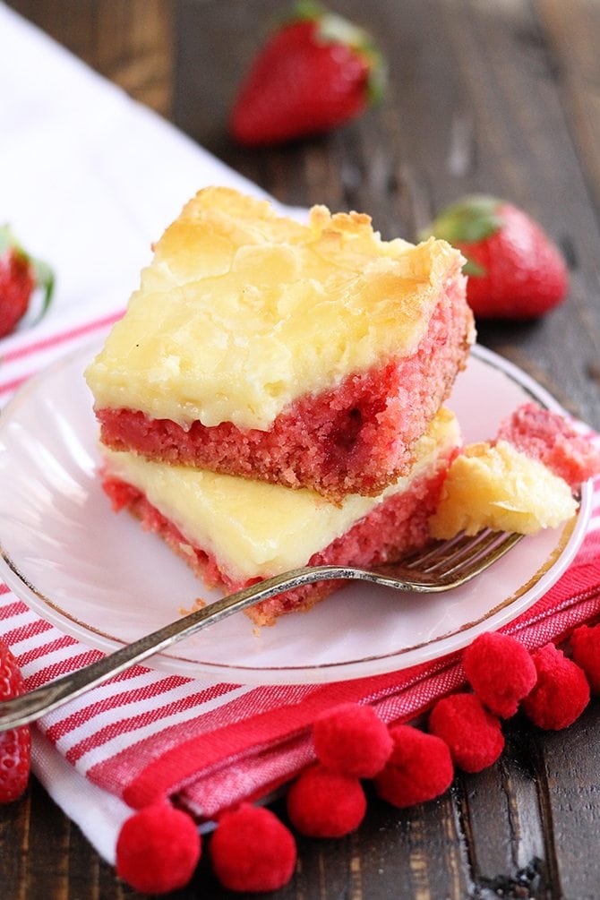 slices of Strawberry Chess Bars stacked with red and white towel