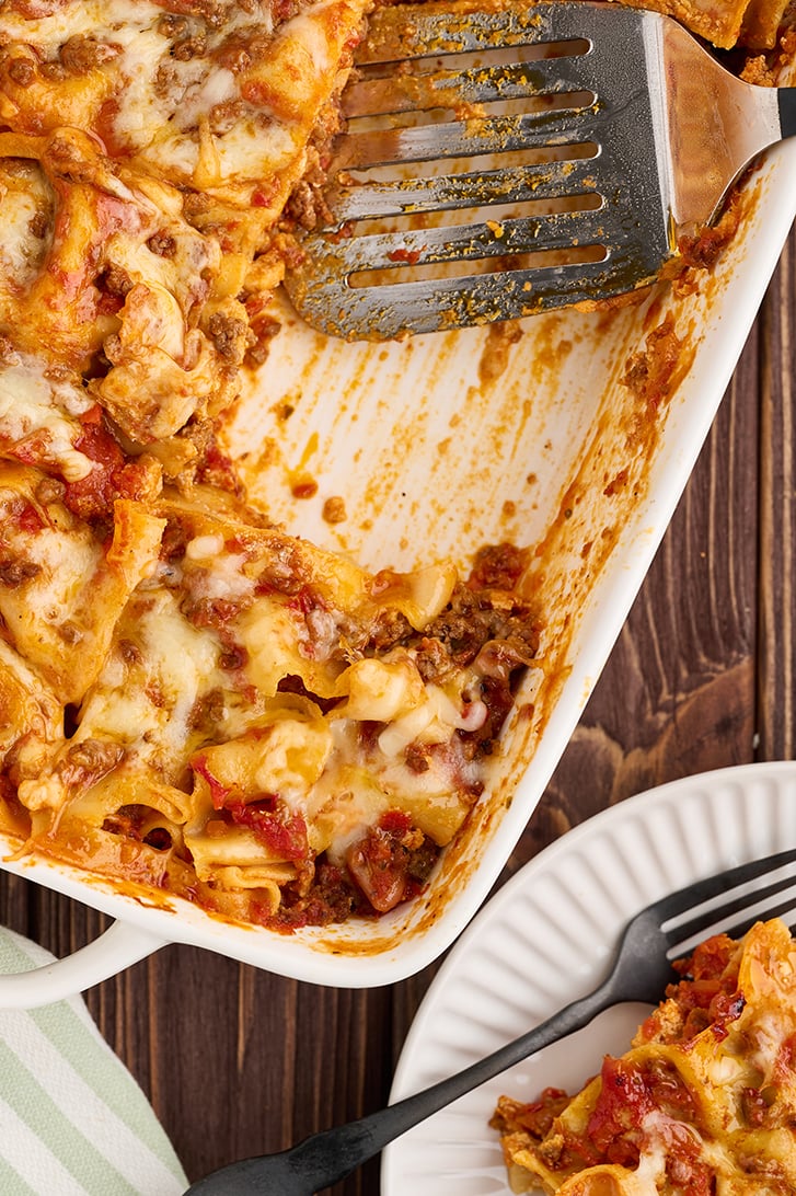Whole lasagna with once piece missing.