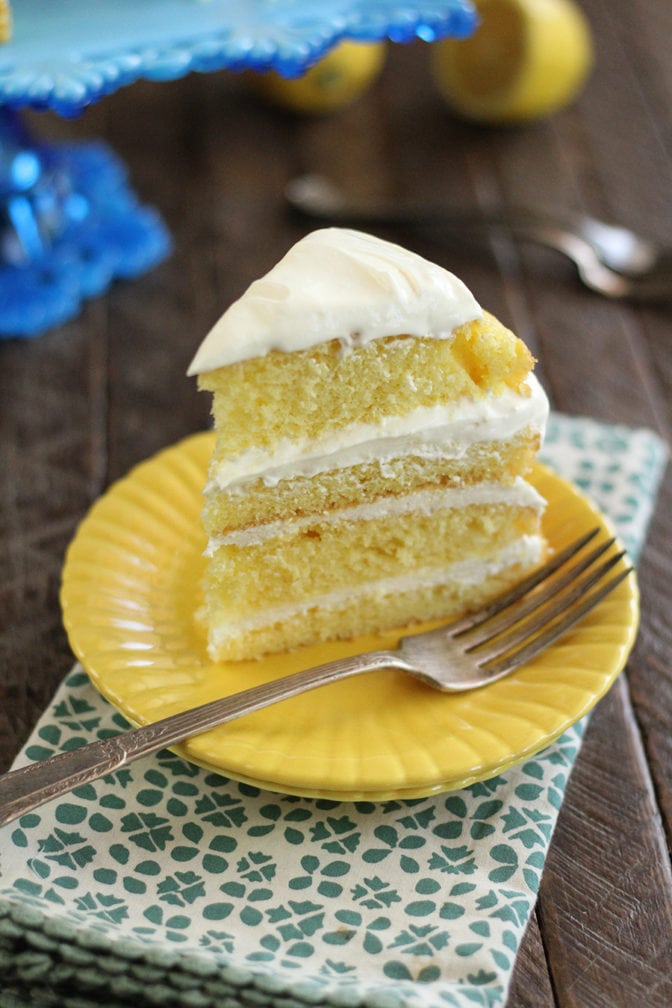 Lemon Cream Cake slice served on yellow plate