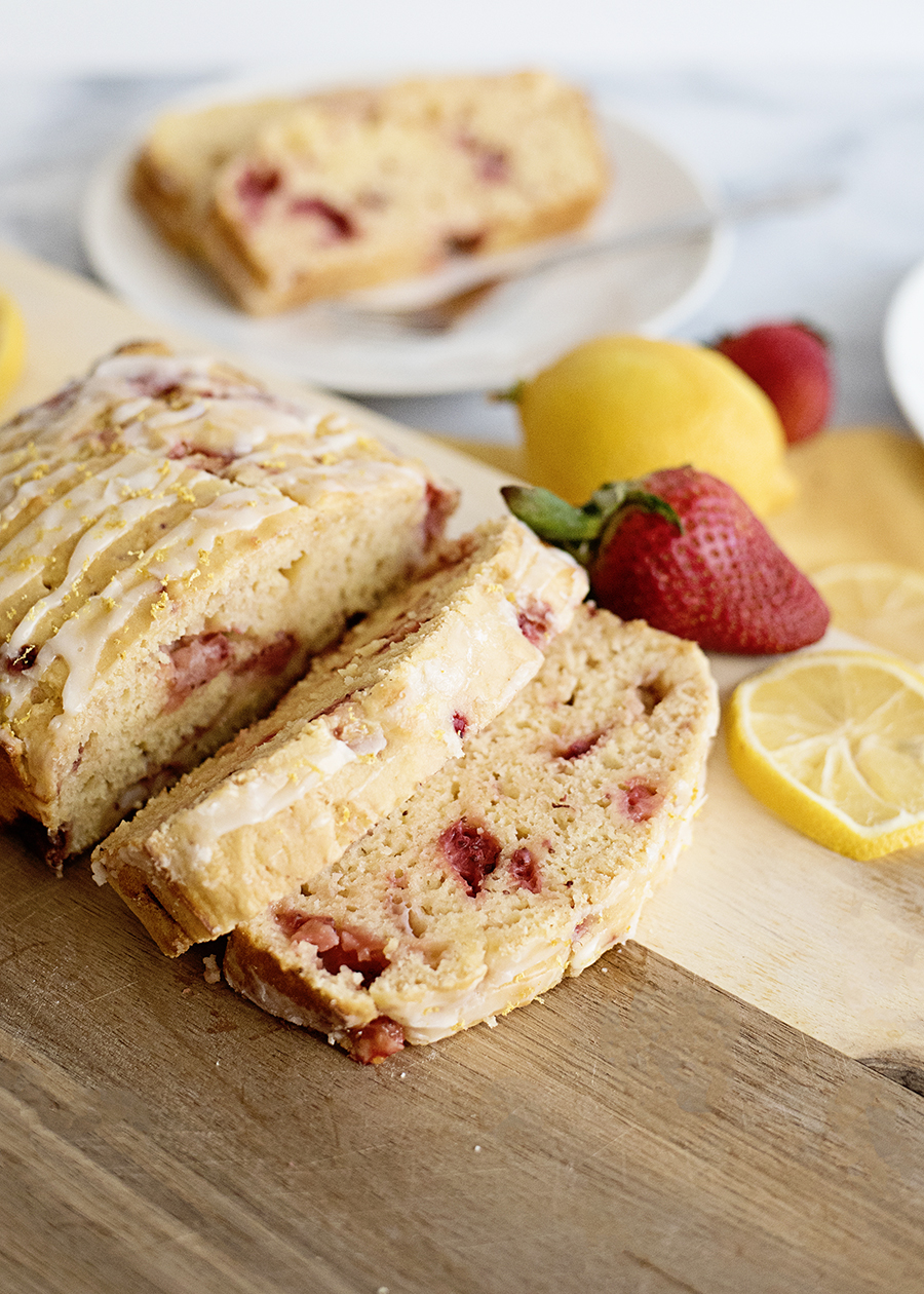 Slices of Strawberry Lemon Yogurt Bread served with fresh strawberries and lemon slices
