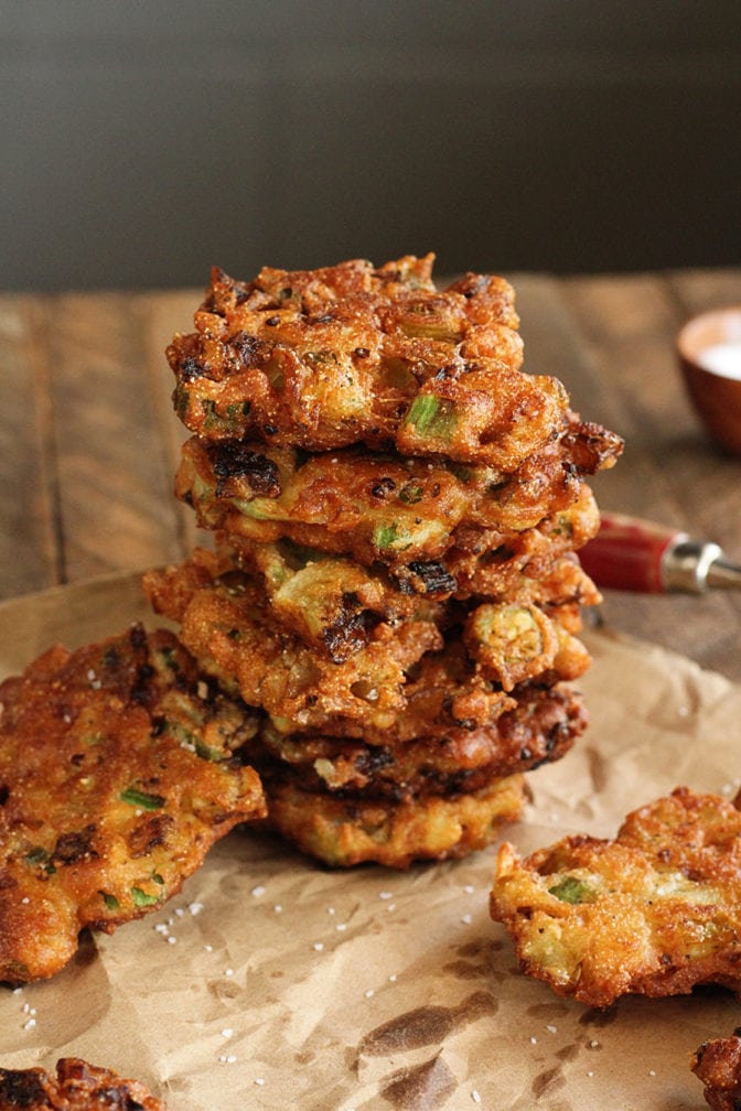 Okra and Green Tomato Fritters stacked on brown parchment paper