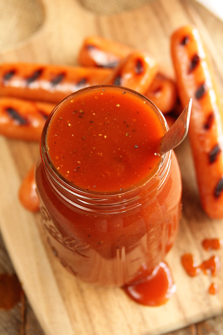 Coca Cola BBQ Sauce with hot dogs in background