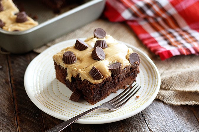 Piece of Chocolate Peanut Butter Poke Cake served fresh from pan