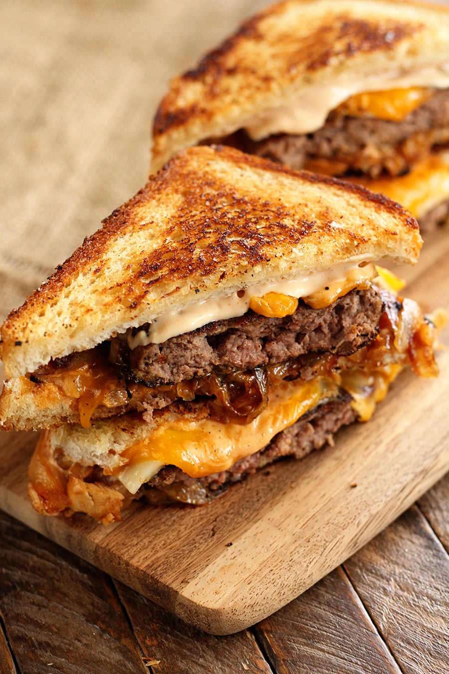 Sliced Patty Melt on wooden serving platter