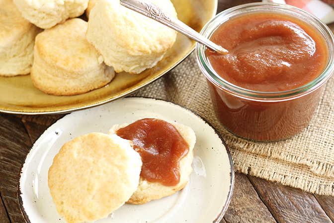 Slow Cooker Apple Butter served with a plate of homemade biscuits