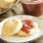 Slow Cooker Apple Butter on biscuit on white plate