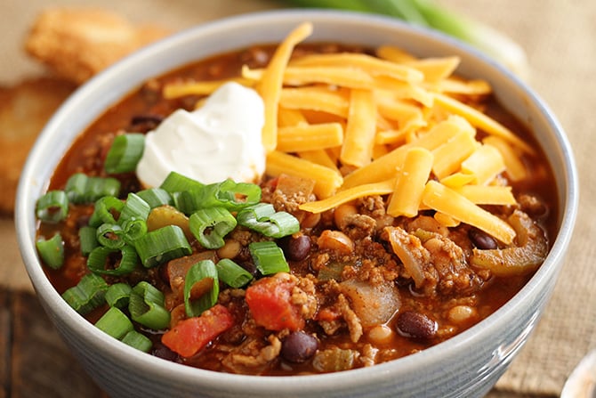 Bloody Mary Chili with toppings of cheese, sour cream and green onions