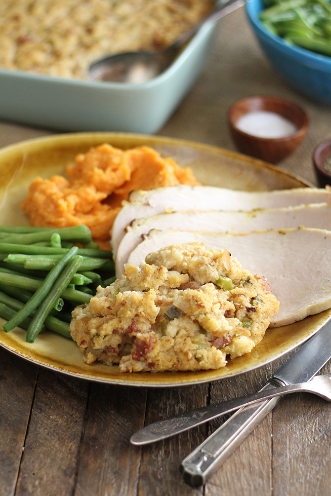Creole Cornbread Dressing served with sliced turkey and vegetables