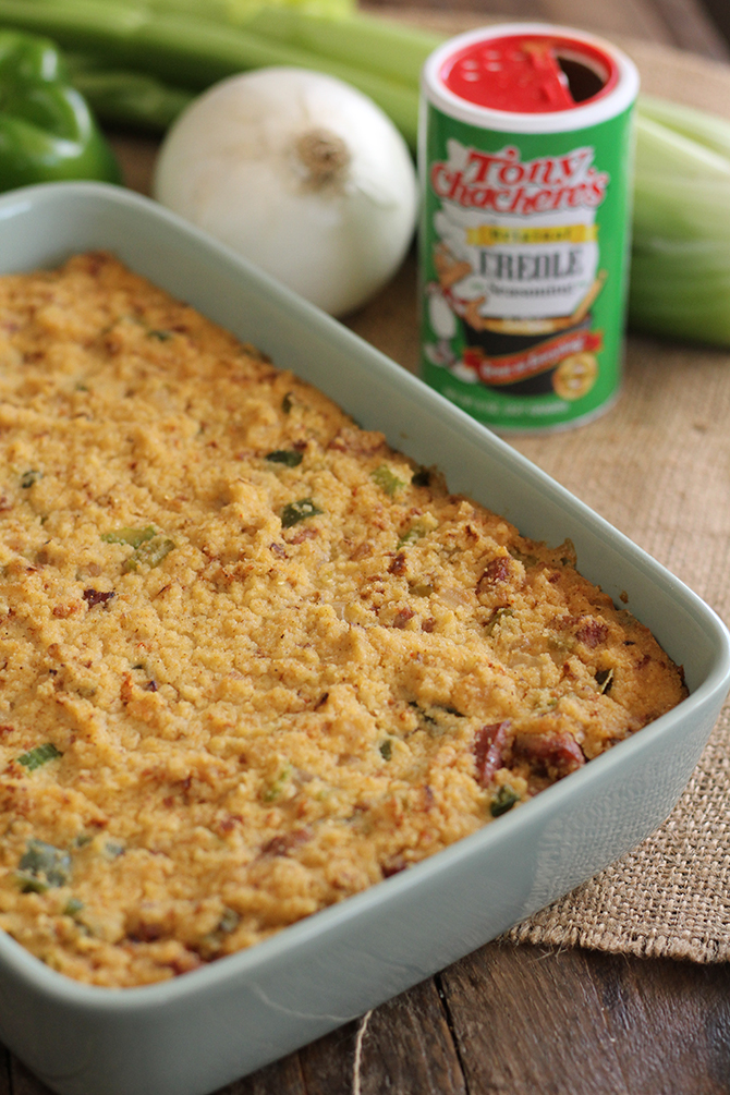 Creole Cornbread Dressing in baking pan with spices in background
