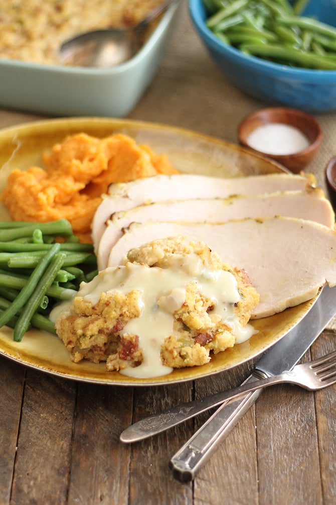 Creole Cornbread Dressing served with sliced turkey and vegetables