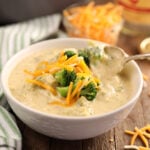 Broccoli an Cheese Soup lifting spoonful out of bowl