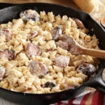 Weeknight Sausage Alfredo in cast iron skillet and break in background
