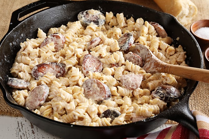 Weeknight Sausage Alfredo served in cast iron skillet